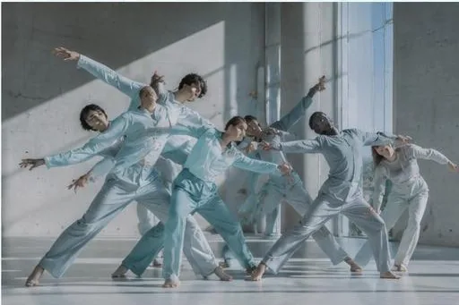 A group of dancers moving in unison