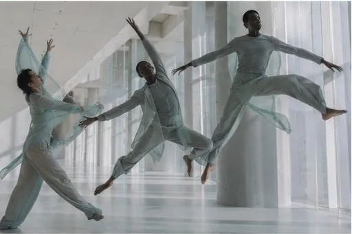 Three dancers mid-jump